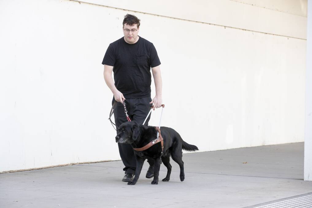 Daniel McKenny and his guide dog Jake, who have been refused Uber rides in Canberra. Picture: Sitthixay Ditthavong