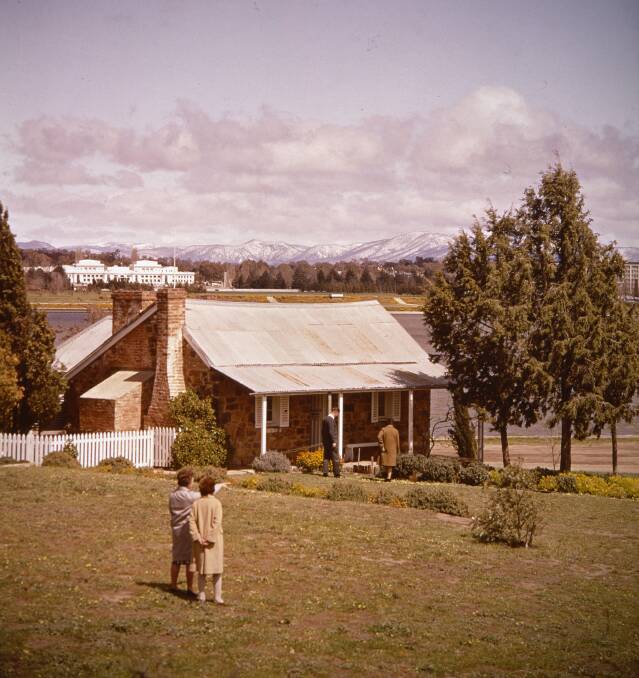Snow sits on the mountains behind Blundell's Cottage in 1968. Picture: National Archives of Australia