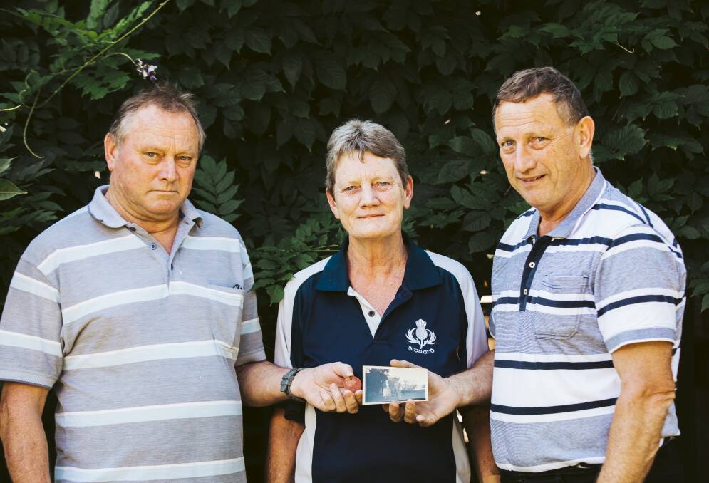 The grandchildren of Sergeant Andrew McNeill with his newly found dog-tag. From left to right are Darrell, Toni and Colin McNeill. Picture: Jamila Toderas
