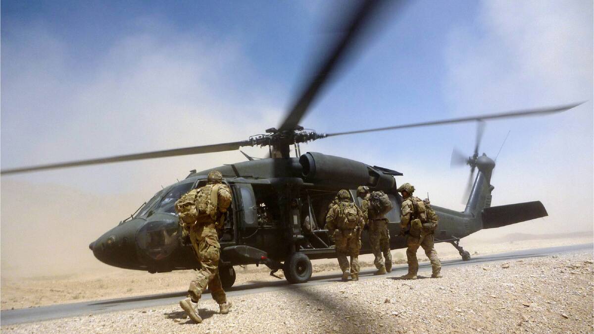 Australian Army soldiers from the Special Operations Task Group board a US Army Black Hawk helicopter in Uruzgan in 2012. Picture: Defence Media