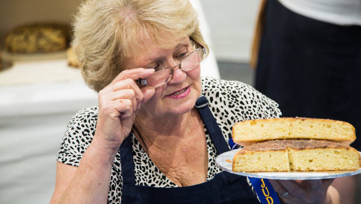 Judge Pat Mulley casts a critical eye over Karen Hardy's cinnamon tea cake. Picture: Ashraf Alreshan