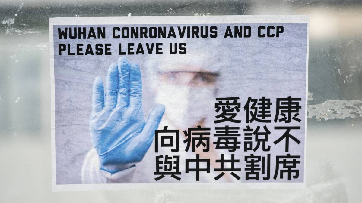 A sign calling for a stop to the spread of coronavirus and the exit of the CCP is seen pasted to a pedestrian bridge in central Hong Kong in February. Picture: Sandra Sanders