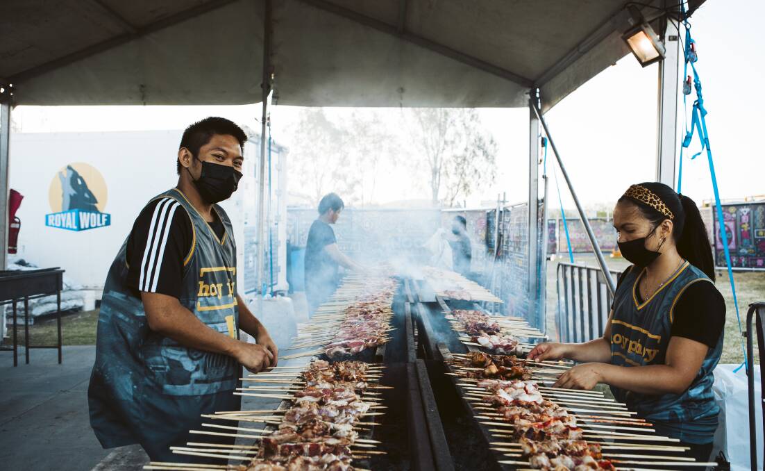 Hoy Pinoy's conga line-type charcoal skewer cooking in action at the Canberra Night Noodle Markets. Picture: Jamila Toderas