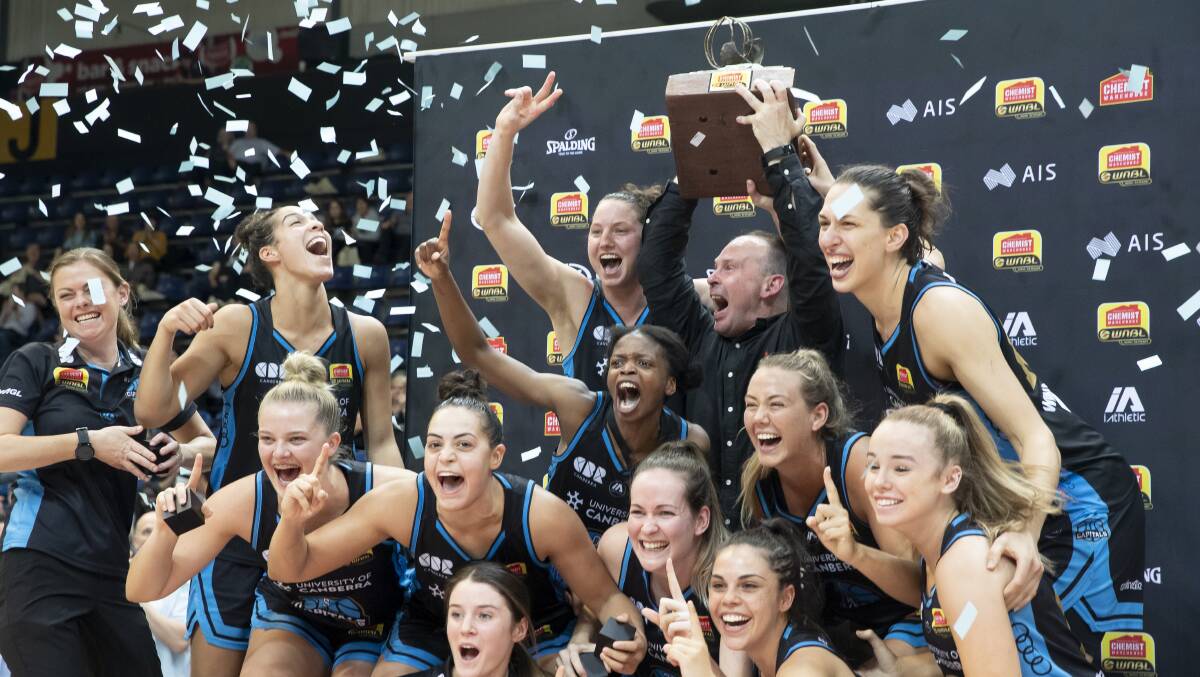 The Canberra Capitals celebrate winning consecutive WNBL championships. Picture: Sitthixay Ditthavong