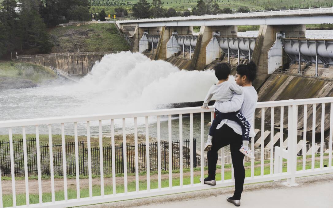 People arrived at Scrivener Dam lookout to see the water flow from the sluice gates. Picture: Dion Georgopoulos