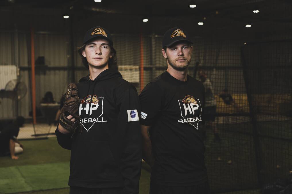 Max Lyddiard with Canberra Cavalry player Kyle Perkins, the coach and organiser of a high-performance program for young baseball players. Picture: Dion Georgopoulos