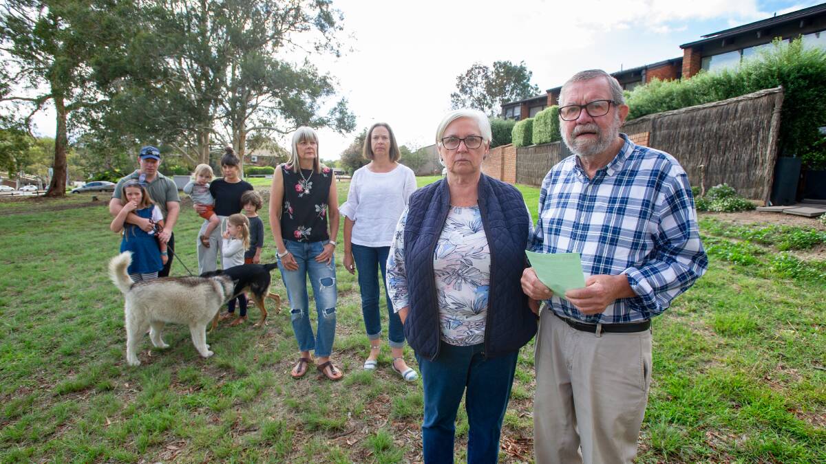 Robyn and John Davies, front, with neighbours who opposed a temporary car park proposed for the open space behind their townhouses in Weston Creek. Picture: Elesa Kurtz