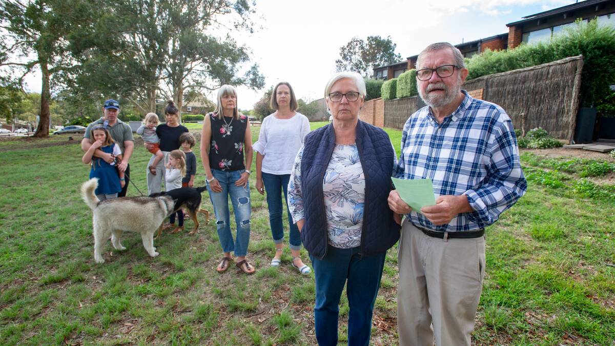 Robin and John Davies with neighbours who oppose a temporary car park proposed for the open space behind their townhouses in Weston Creek. Picture: Elesa Kurtz