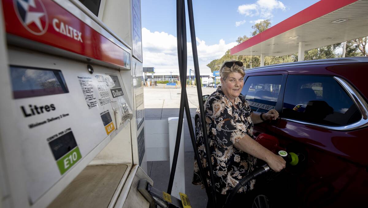 Sally Wood keeps an eye on petrol prices between Queanbeyan and Canberra. Picture: Sitthixay Ditthavong. 