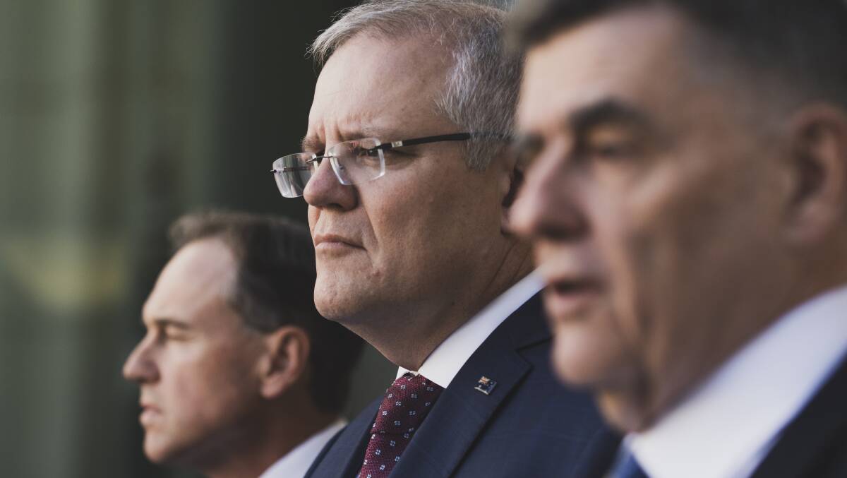 Prime Minister Scott Morrison at a press conference with Health Minister Greg Hunt, left, and Chief Medical Officer Brendan Murphy. Picture: Dion Georgopoulos