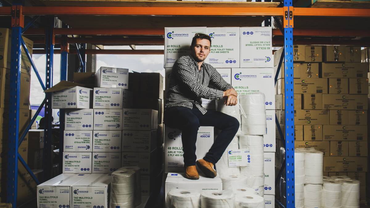 Chemworks business development manager and director Jackson Barnes with the toilet paper stocks which are rolling out the warehouse door. Picture: Dion Georgopoulos