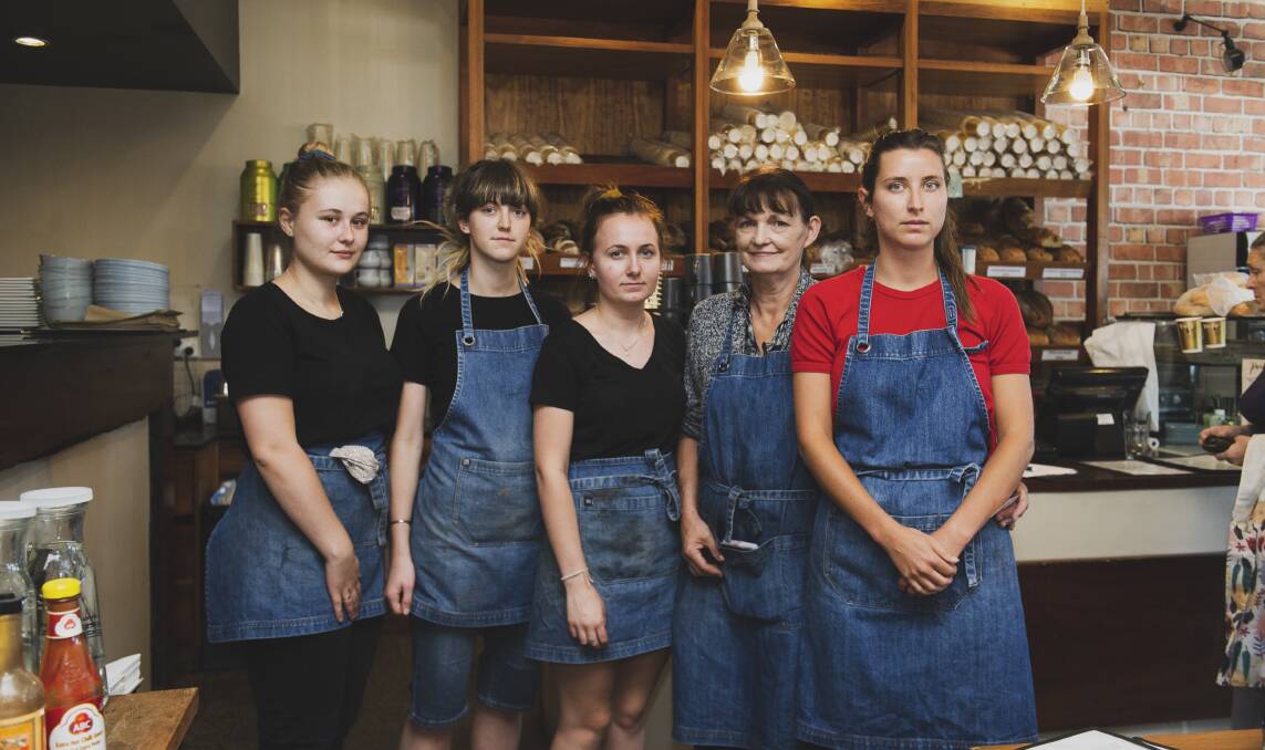 Coco and Rye owner Carol Small with her staff Ella Hickey, Meave Greenspeed, Lauryn Angel and Tess Brackenreg about midday on Sunday. The ACT government announced a shutdown of all non-essential services on Sunday evening. Picture: Dion Georgopoulos