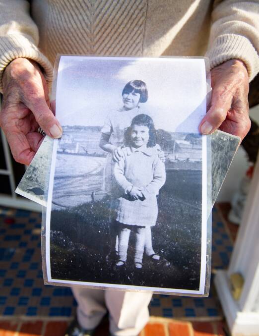 Dawn Waterhouse holds a picture of herself with her older sister Del, both children during the Great Depression and World War II. Picture: Elesa Kurtz