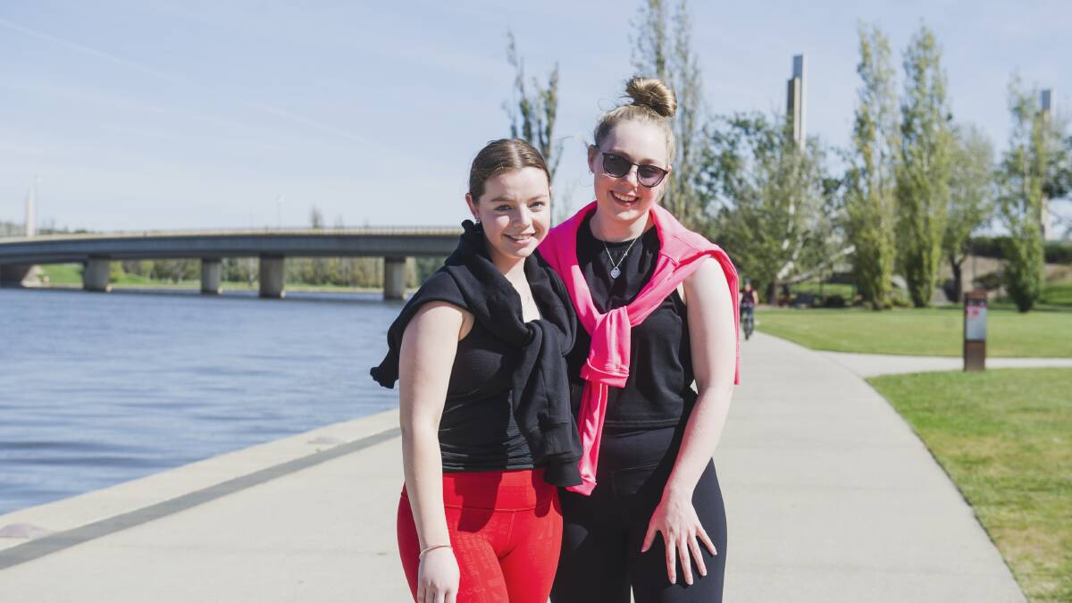 Isabella Donaldson and Georgie Graney enjoy a walk around Lake Burley Griffin on Saturday. Picture: Dion Georgopoulos. 