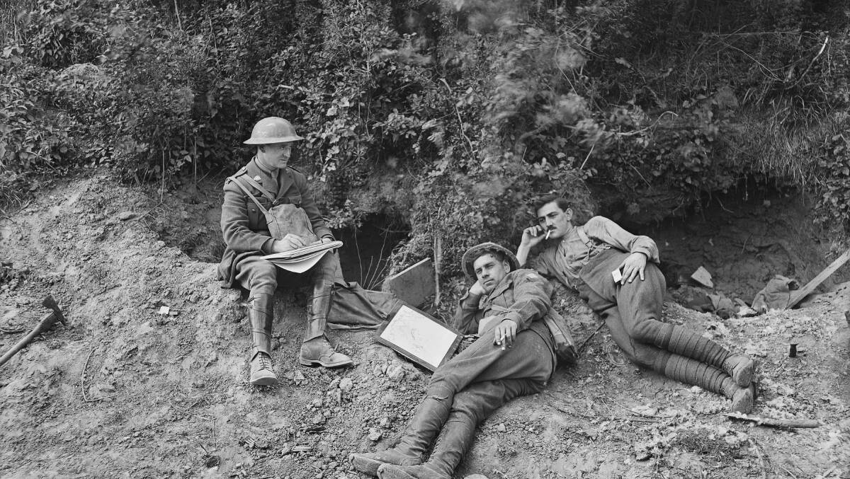 Lieutenant Will Dyson sketching, in the 'Caterpiller', an intersection of two sunken roads. Two other men rest and smoke a cigarette. May, 1918