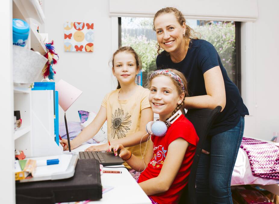 Emma Davidson with two of her children, Jessica, 7, and Lucy, 9, preparing for Term 2. Picture: Jamila Toderas 