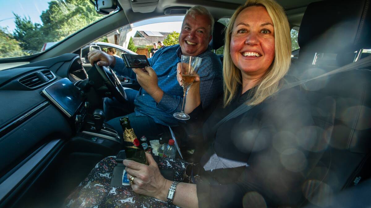 The couple's friends David and Leanne Sheard, of Bywong, watched the ceremony from their car with champagne. Picture: Karleen Minney