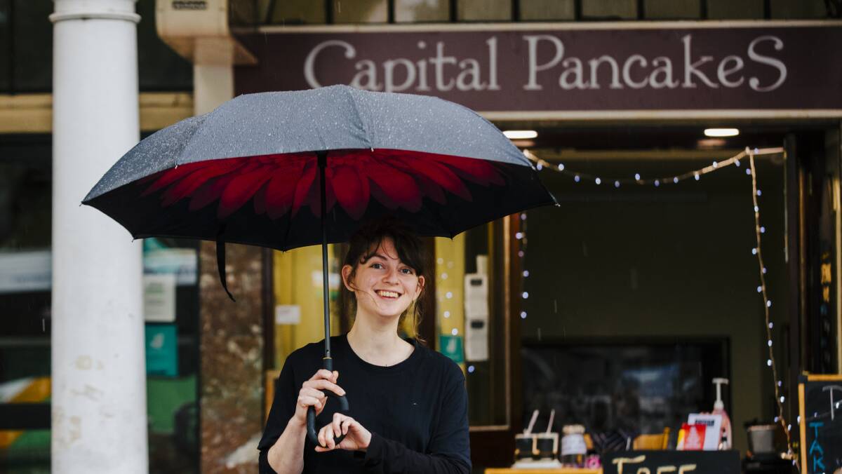 Capital Pancakes staff member Steph McQualter out in the rain on Wednesday. Picture: Jamila Toderas
