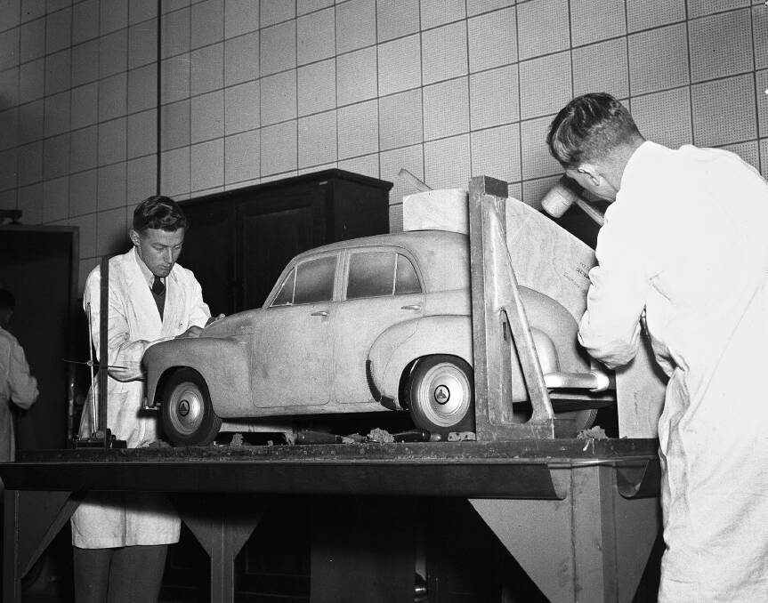  Holden designers working with a clay model of the original FJ sedan.
