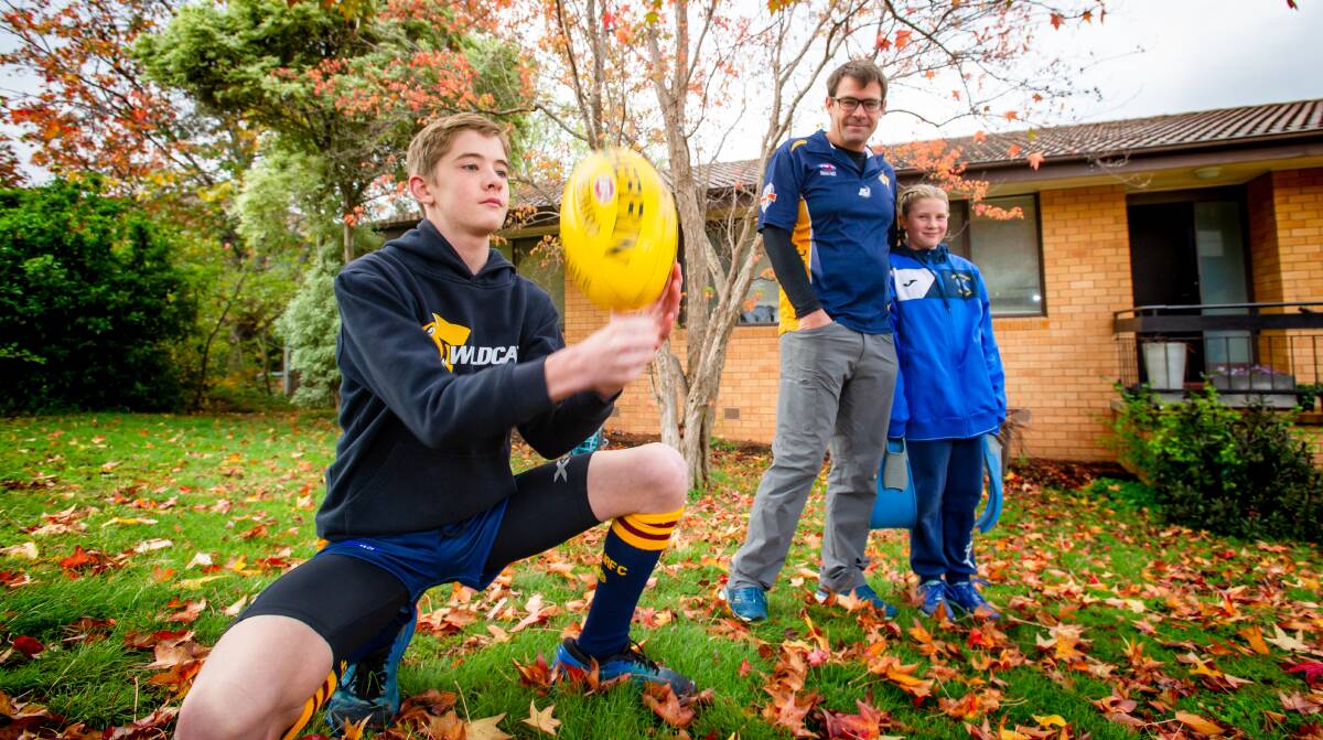Kai Swoboda (centre), represented Australia in canoeing at the Sydney 2000 Olympics, he coaches the AFL team his son, Max, 12, plays in. Kai's daughter, Elise, 10, plays soccer and is a competitive swimmer. Picture: Elesa Kurtz
