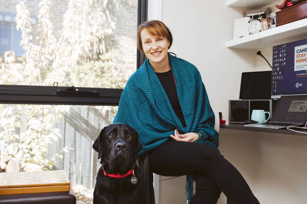 Housing ACT executive group manager Louise Gilding, at her home office with her dog Jackson. Picture: Jamila Toderas 