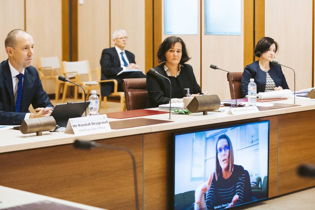 Digital Transformation Agency chief executive Randall Brugeaud, acting Health secretary Caroline Edwards and Attorney-General's Department deputy secretary Sarah Chidgey answer questions from Nationals senator Perrin Davey via video conference. Picture: Jamila Toderas