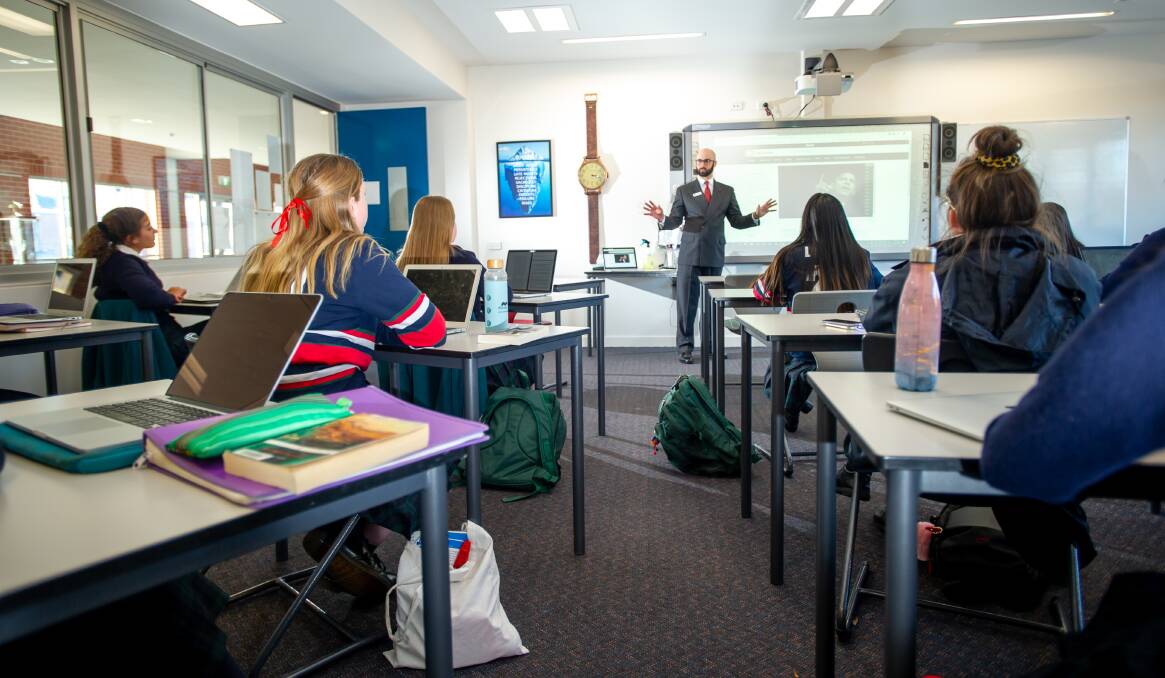 Canberra Girls Grammar teacher Eamonn McGill teaches a year 11 and 12 English class on their return to school. Picture: Karleen Minney