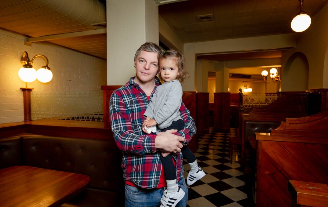 Capital Pancakes manager Jefferson Barton with daughter Serene, two, in the empty restaurant on Friday. Picture: Elesa Kurtz 