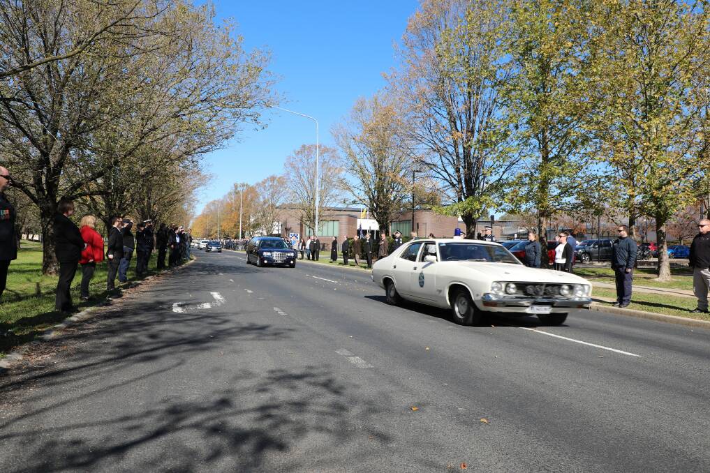 Police respectfully line the Belconnen roadway for the funeral procession for Sergeant Andrew Warry. Picture: Supplied
