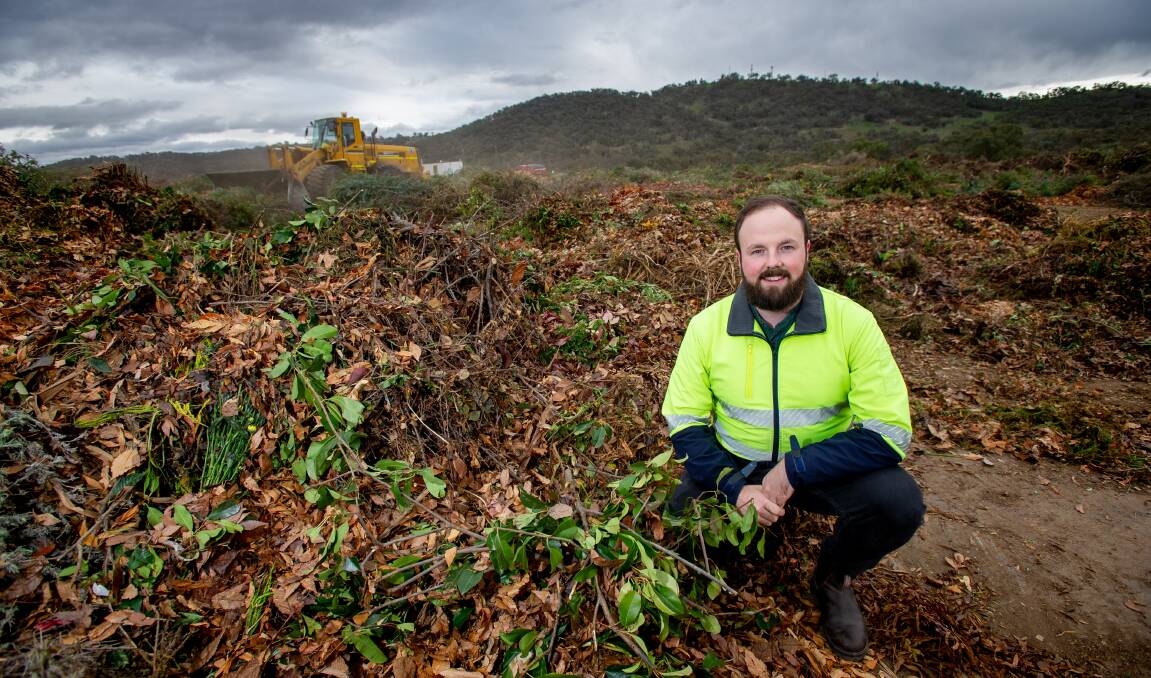 EnviroCom green waste education officer Jules Watson with green waste at the Corkhill Bros green waste site at the Mugga Lane tip on Friday. Picture: Elesa Kurtz 