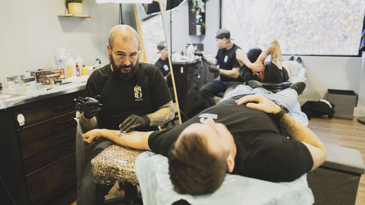Tattoo artist at Freestyle Tattoo Studio in Civic Ben Angelidis tattooing a client. Picture: Dion Georgopoulos