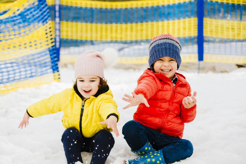 Siblings Hiera Efatmanesh, 3, and Emilian Efatmanesh, 5, bringing in winter early with snow play at Corin Forest on Sunday. Picture: Jamila Toderas