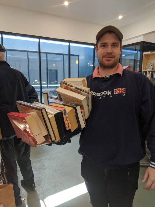 Customer Laurence Kelson, of Amaroo, bought an arm-full of books.