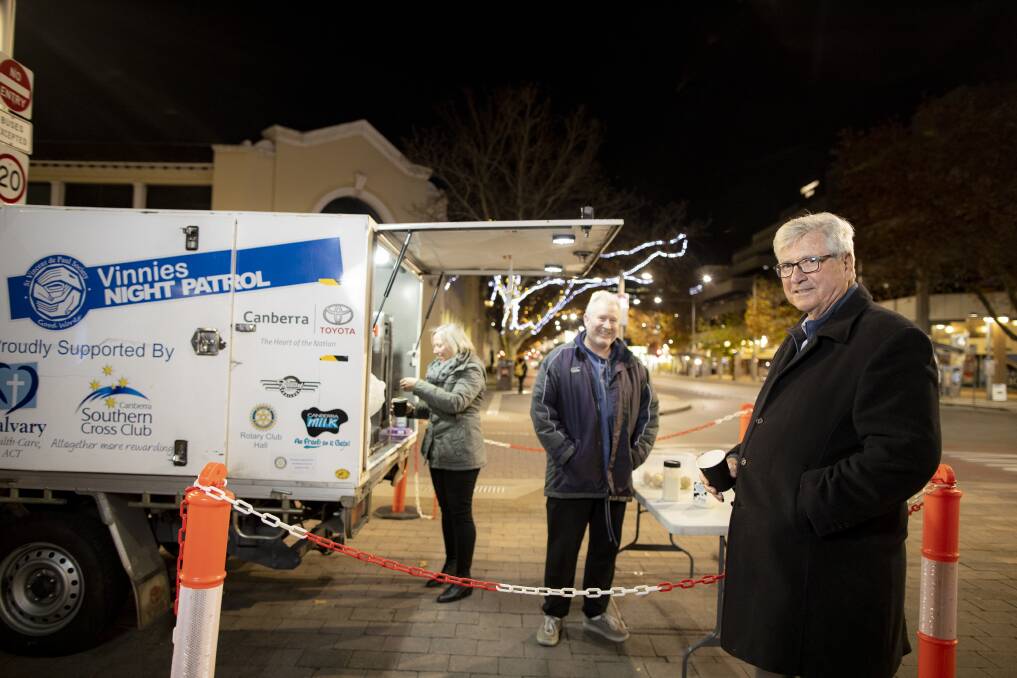 Winter is a tough time for those in need. Hands Across Canberra CEO Peter Gordon (right) this week with Vicki and Brian Kinnane, who have volunteered with Vinnies Night Patrol for more than 15 years. Picture: Sitthixay Ditthavong 