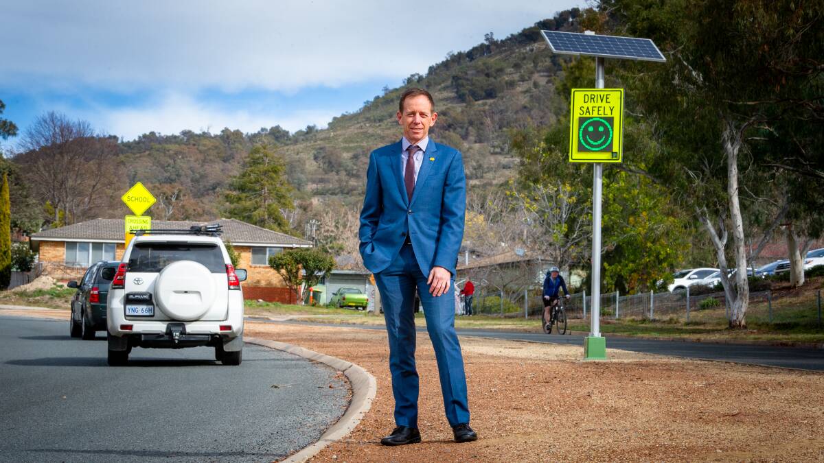 Road Safety Minister Shane Rattenbury with the smiley face road sign, which has proven a success while under trial in the ACT. Picture: Elesa Kurtz
