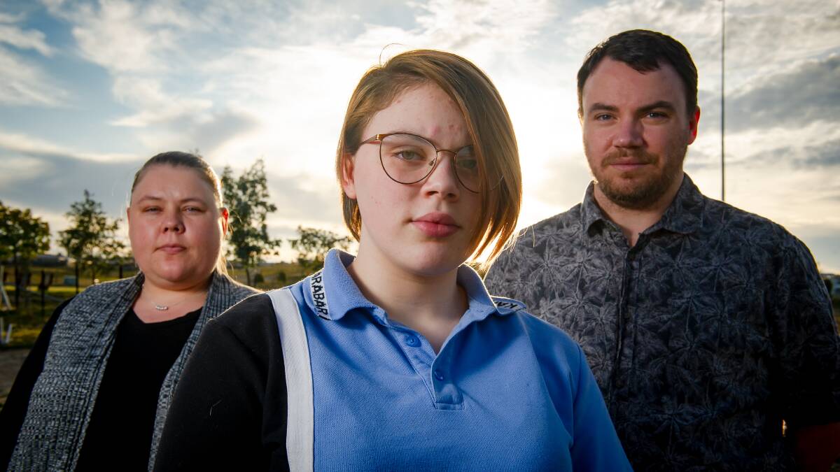Maya Long, 14, pictured with her parents Carly and Brad, had very severe asthma during the smoke from the fires and had to leave the city. Picture: Elesa Kurtz