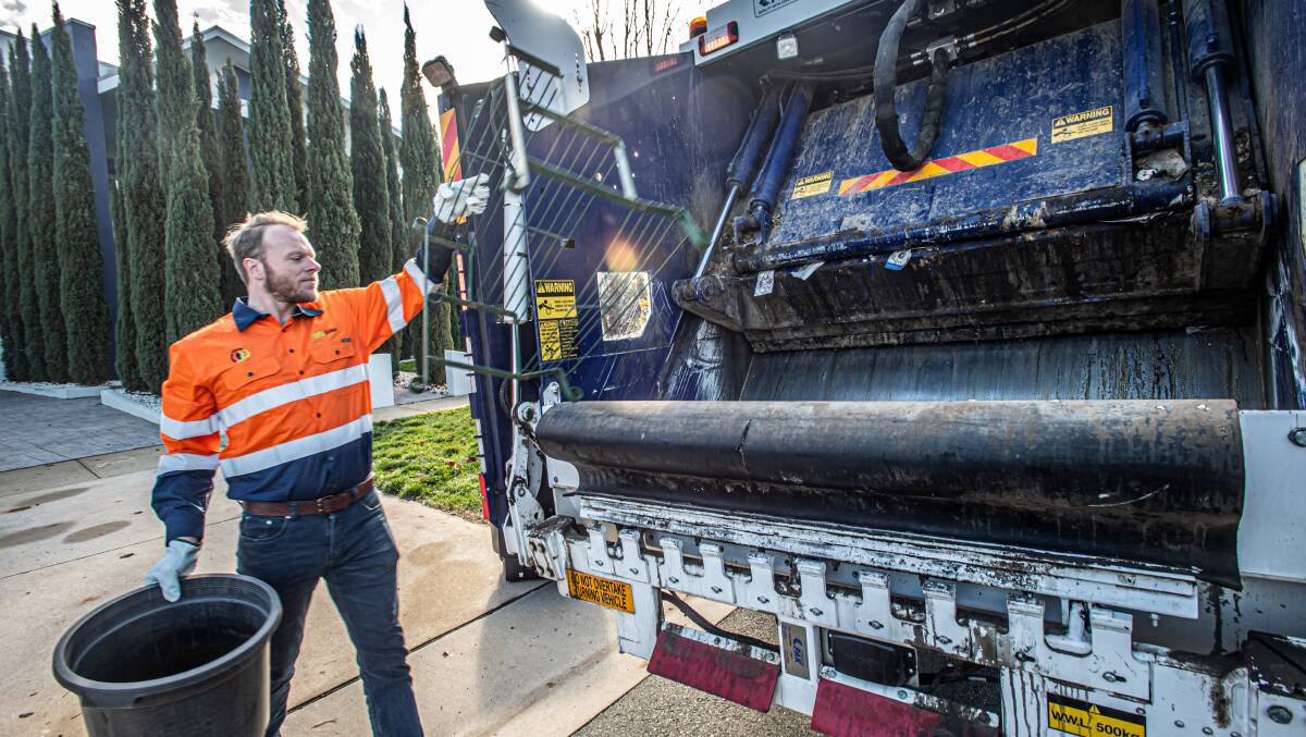 The bulky waste collection service will start in mid July for households in Tuggeranong and Gungahlin.
Suez Commercial operations manager Mitchell Palmer takes some hard waste away from a Crace home. Picture: Karleen Minney