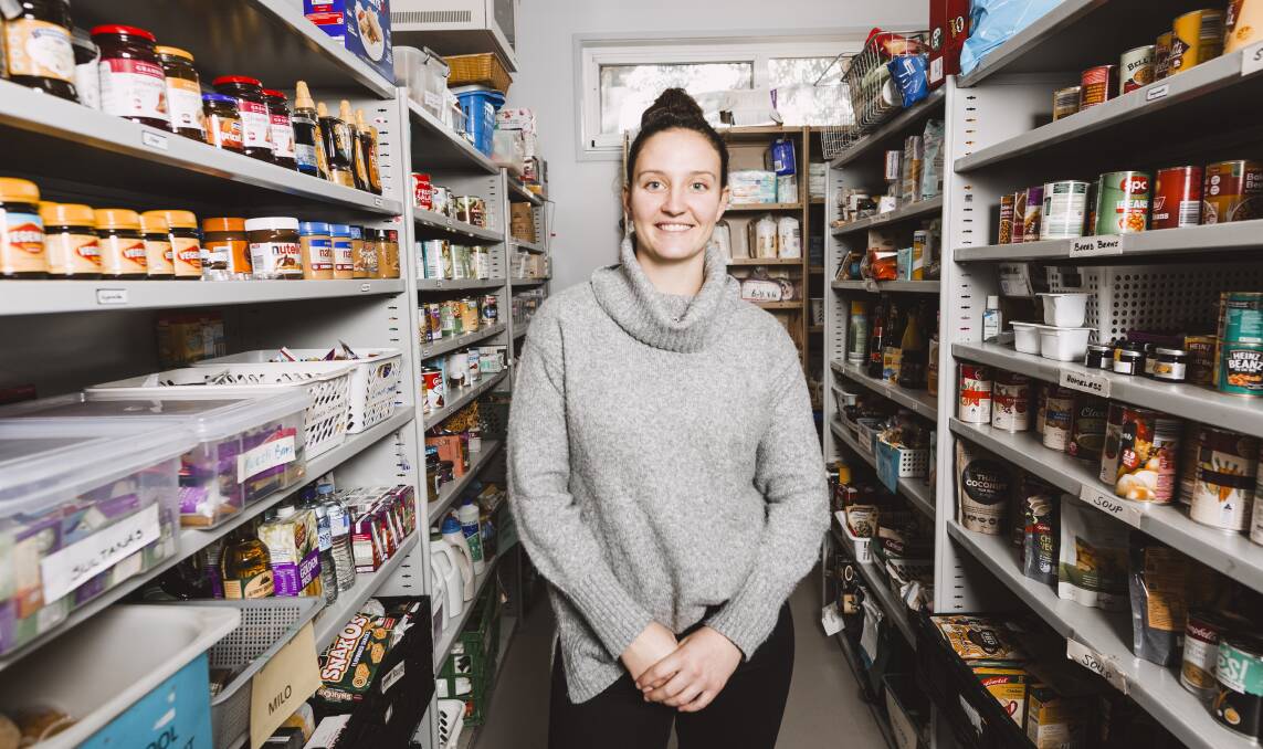St John's Care volunteer Katie Glover in the pantry of donated food. Picture: Jamila Toderas 