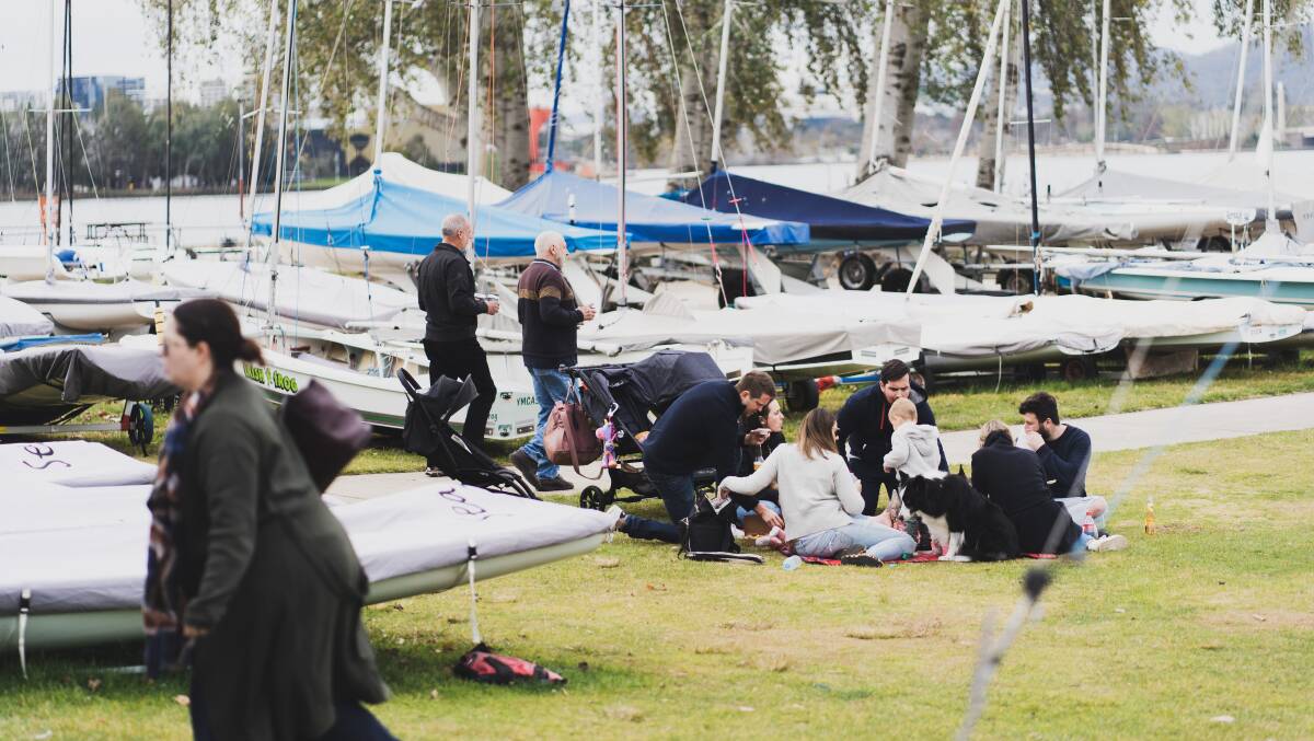 People enjoying a picnic outside the Canberra Yacht Club following the easing of restrictions in outside areas this month. Picture: Dion Georgopoulos
