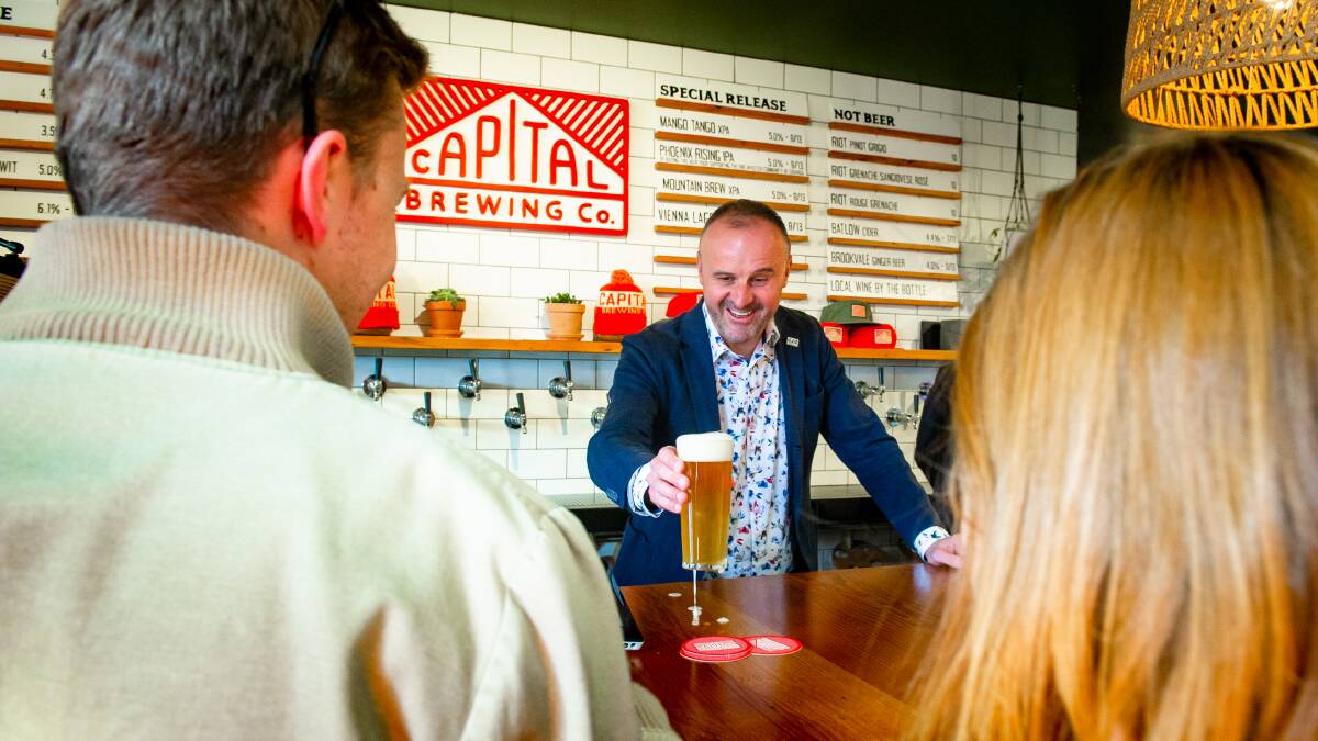 Chief Minister Andrew Barr serves up first beers at Capital Brewing Co after restrictions eased at midday last Friday. Picture: Elesa Kurtz 