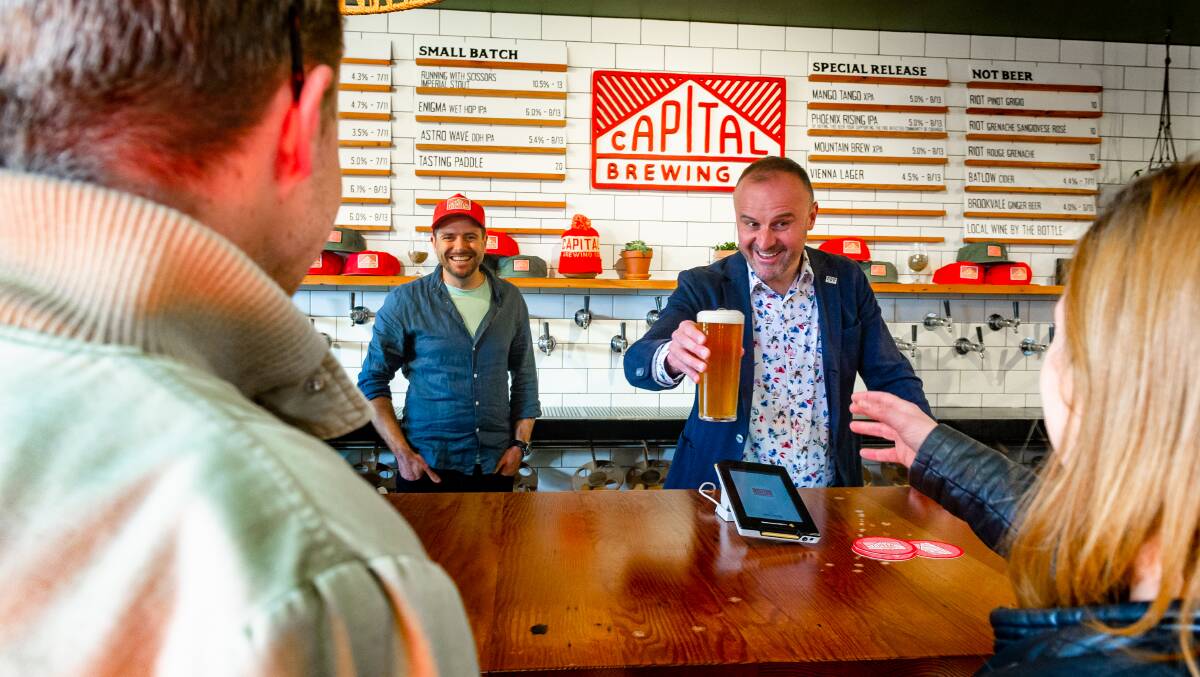 Chief Minister Andrew Barr serves up first beers with Capital Brewing managing director Laurence Kain, as restrictions eased at midday on Friday, allowing up to 100 people per room. Picture: Elesa Kurtz 