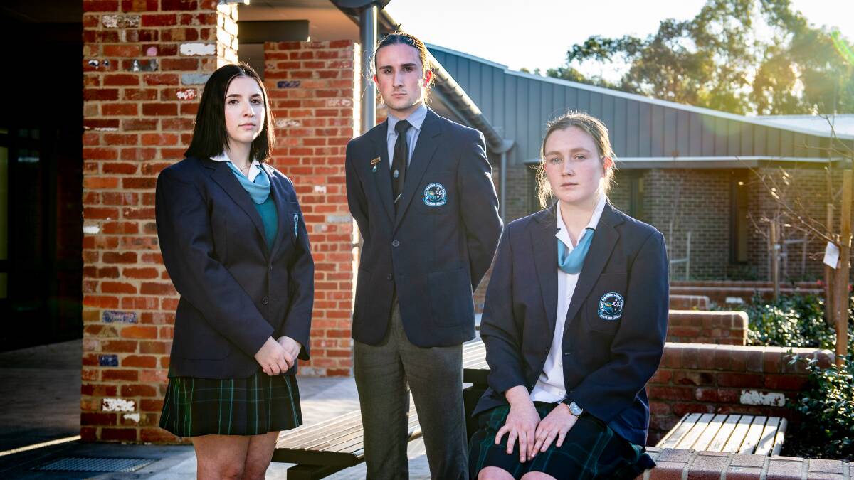 Mary MacKillop College year 12 students Julia Del Bianco, Dylan Slattery and Caitlyn Williams discuss the changes to university fees. Picture: Elesa Kurtz
