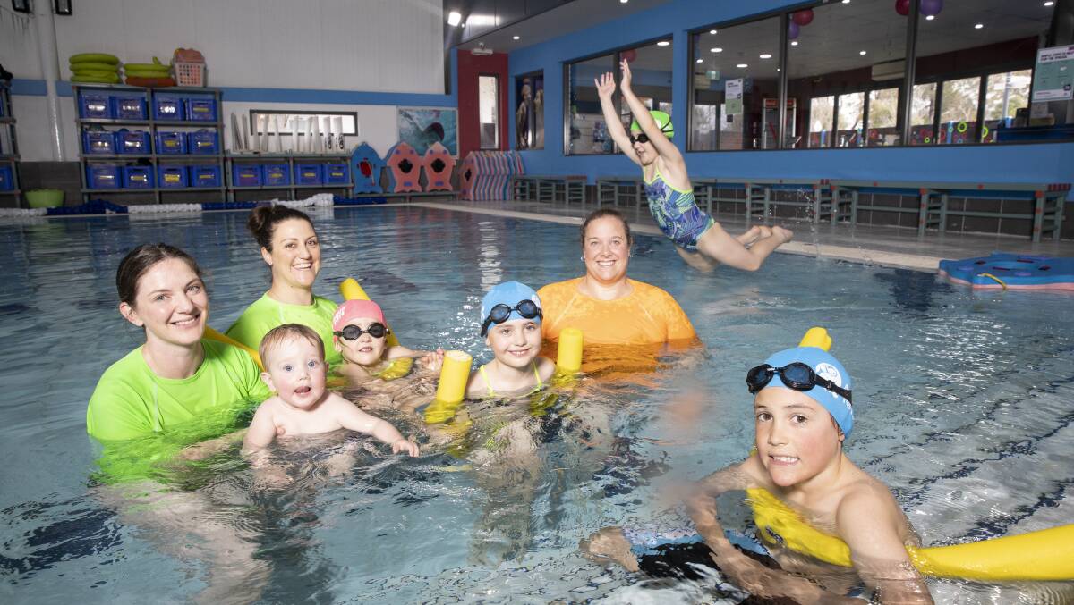 Swimming lessons will soon resume at Aquatots in Forde. L-R: Pia Evans, Theo Evans, manager Alena Sarri, Evie Sarri, Camilla Sarri, manager Rhiannon Kocmar, Carla Sarri, and Arli Willey. Picture: Sitthixay Ditthavong