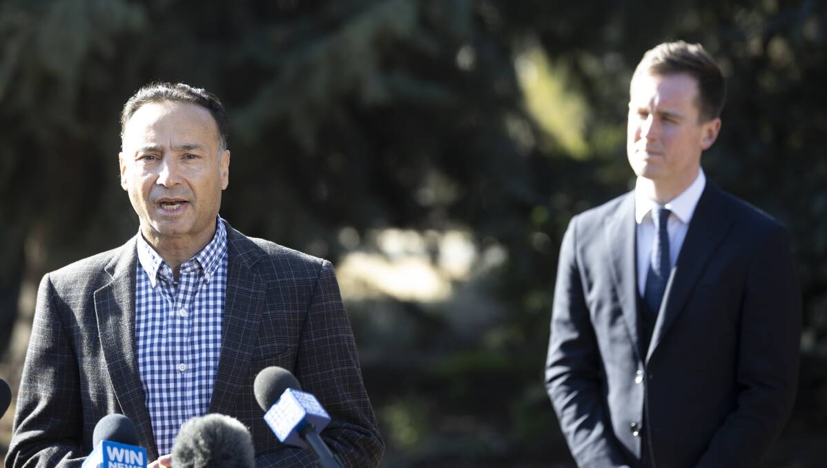 Gungahlin MLA Deepak-Raj Gupta (left) and City Services Minister Chris Steel speak at the sod-turning for a new publicly owned crematorium at Gungahlin Cemetery on Friday. Picture: Sitthixay Ditthavong