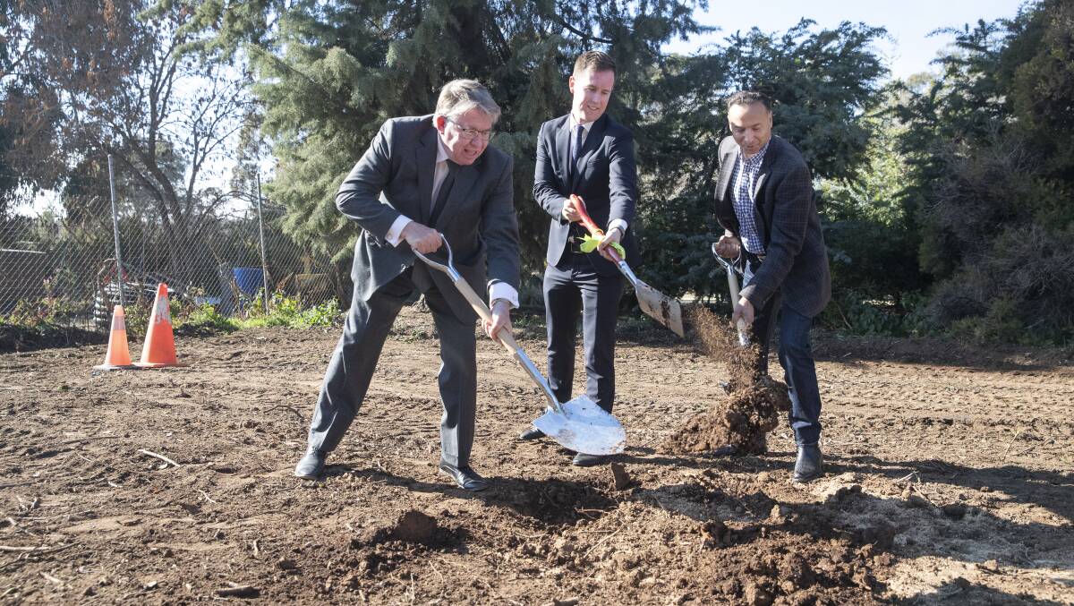 Stephen Bartos, Gungahlin MLA Deepak-Raj Gupta and minister for City Services Chris Steel turn the sod for a new publicly-owned crematorium at Gungahlin Cemetery on Friday. Picture: Sitthixay Ditthavong