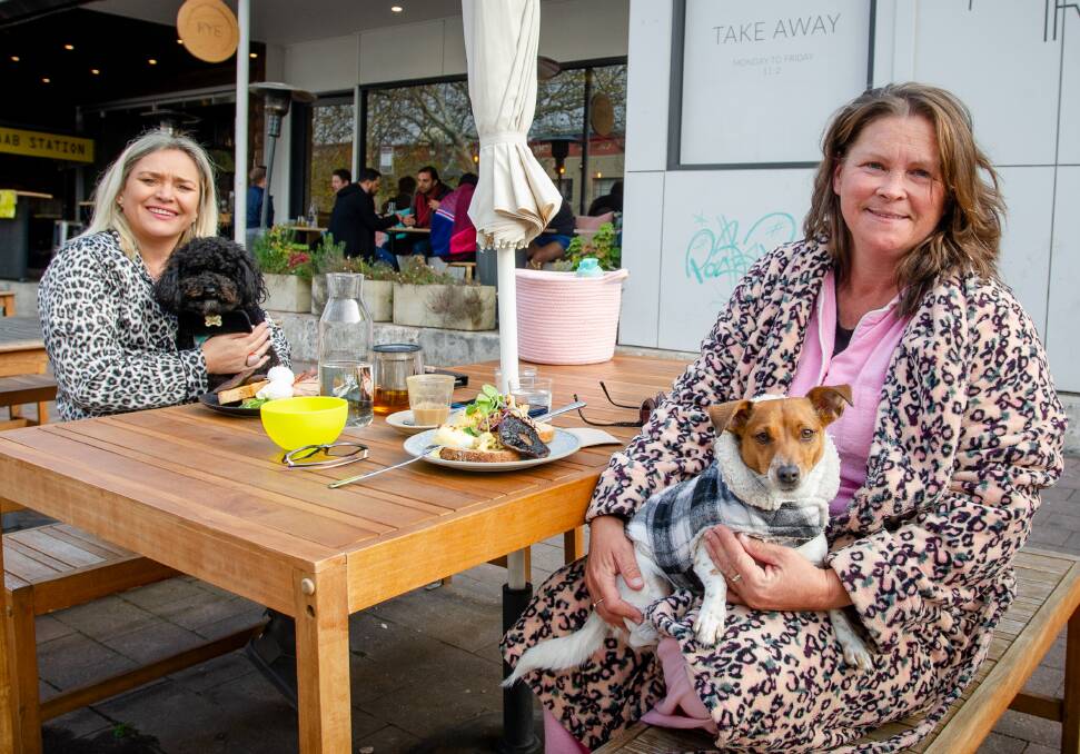 Carly-Ann Andrews-O'Donoghue and her friend, Deidrie Myer, with their dogs Tiana and Missy at Rye Cafe. Picture: Elesa Kurtz