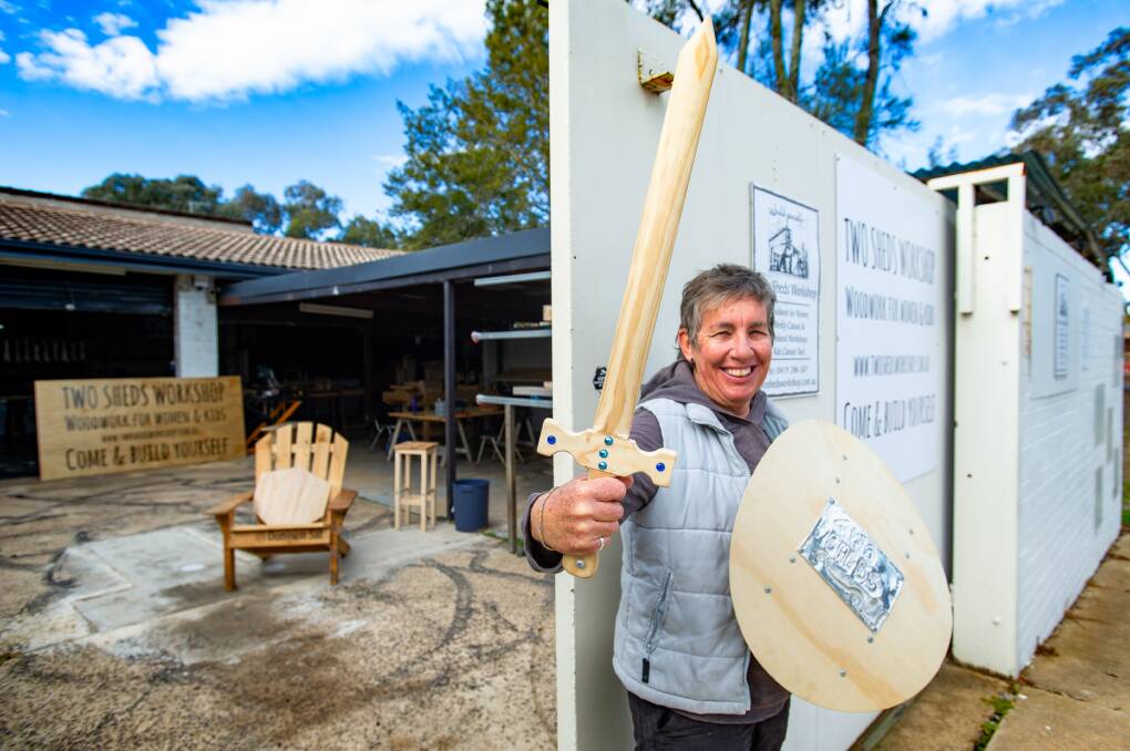 Two Sheds Workshop woodwork teacher, Miche Hodgetts with example of what kids can make in the classes, a sword and shield. Picture: Elesa Kurtz