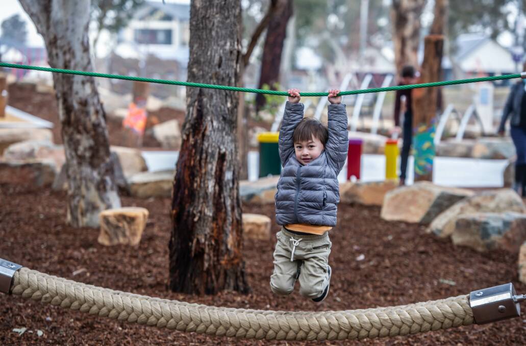 Four-year-old Emmet Forde of Isabella Plains plays on the equipment at the newly opened play space in Kambah. Picture: Karleen Minney