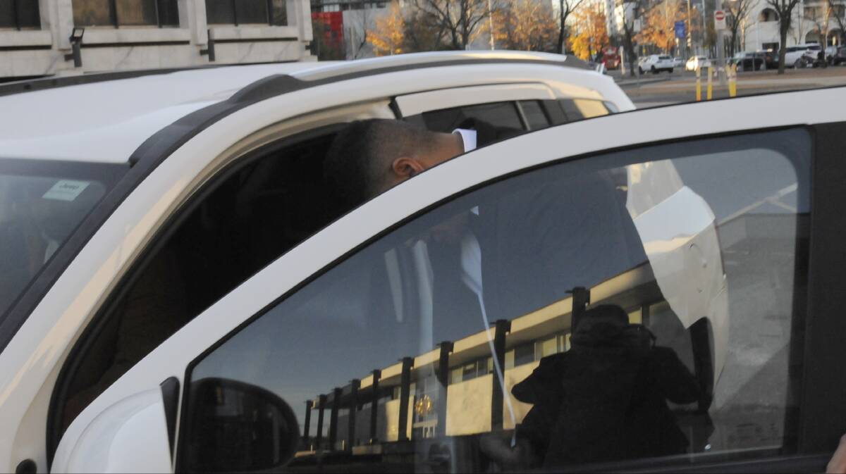 Ropati Dominic Finau hurries into a car outside the ACT Supreme Court during his trial. Picture: Cassandra Morgan
