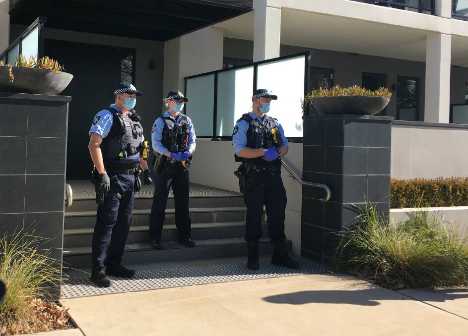 Police outside The Burbury in Kingston, waiting to conduct a spot-check on a quarantine guest. Picture: Peter Brewer
